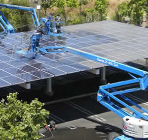 Solar panel cleaning from a cherry picker